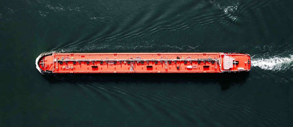 a large red boat in a body of water