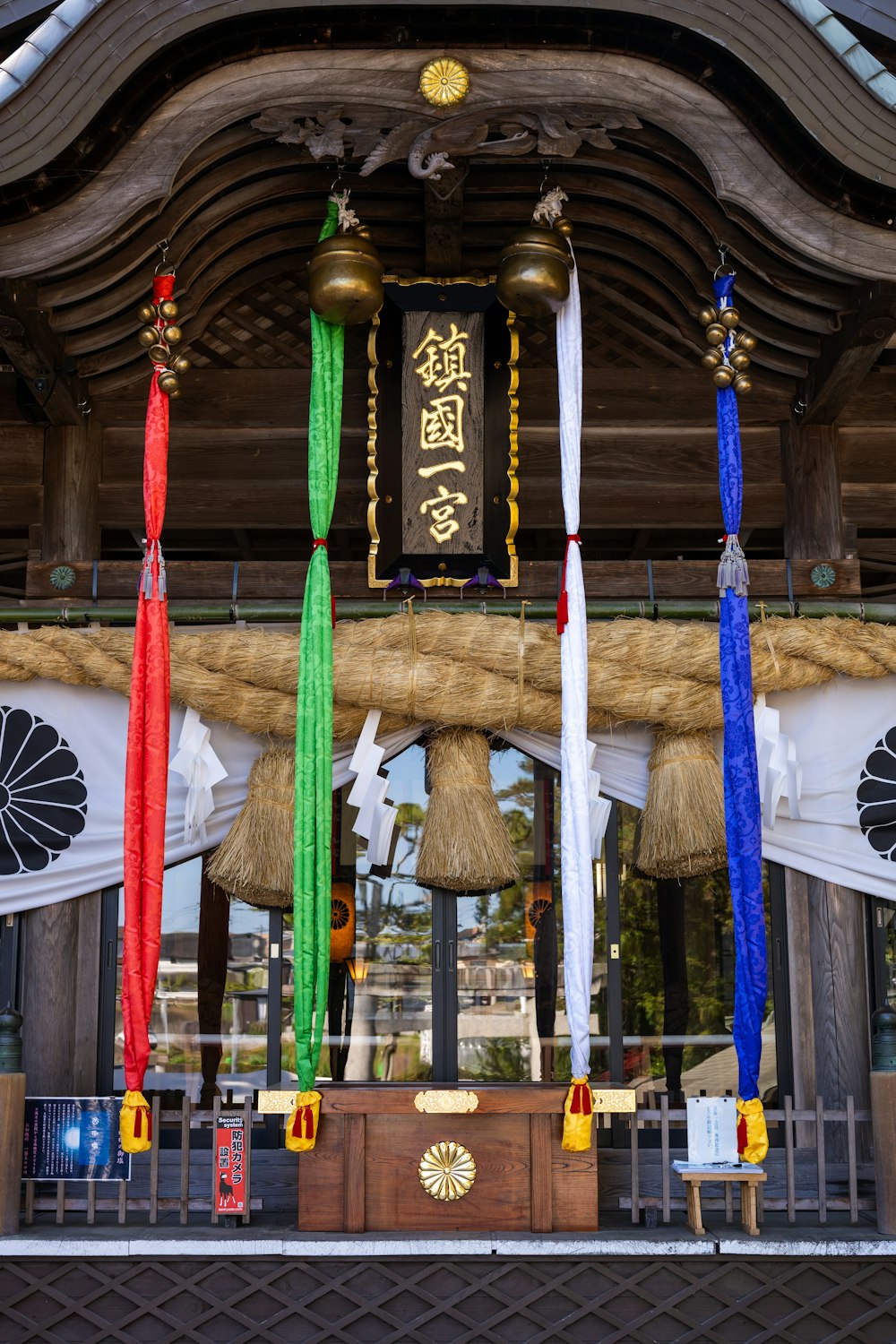 a shrine with bells and banners hanging from it