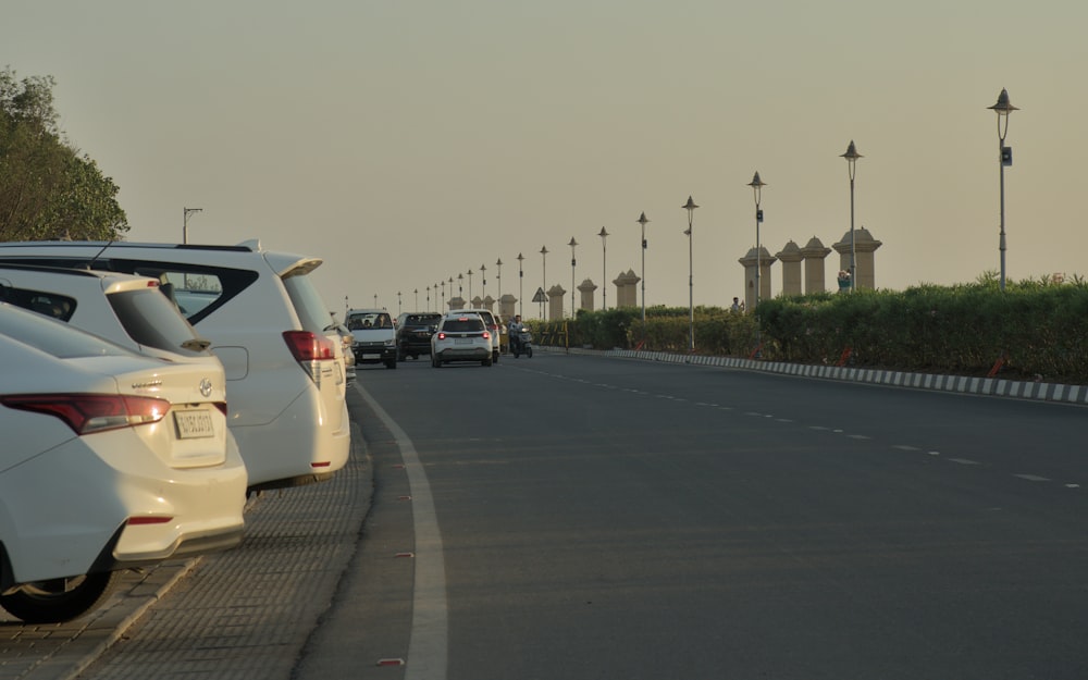 a row of cars parked on the side of a road