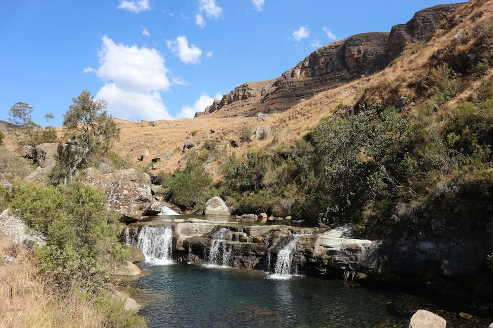 a small waterfall in the middle of a valley