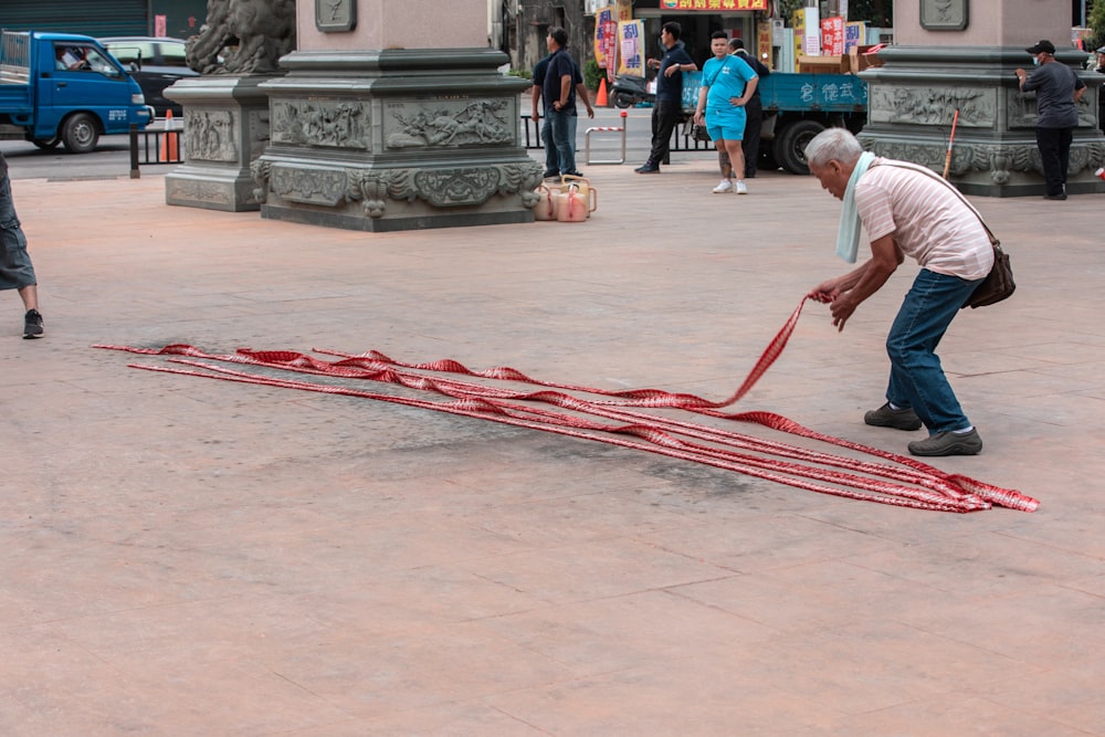 a man working on a piece of art in a plaza