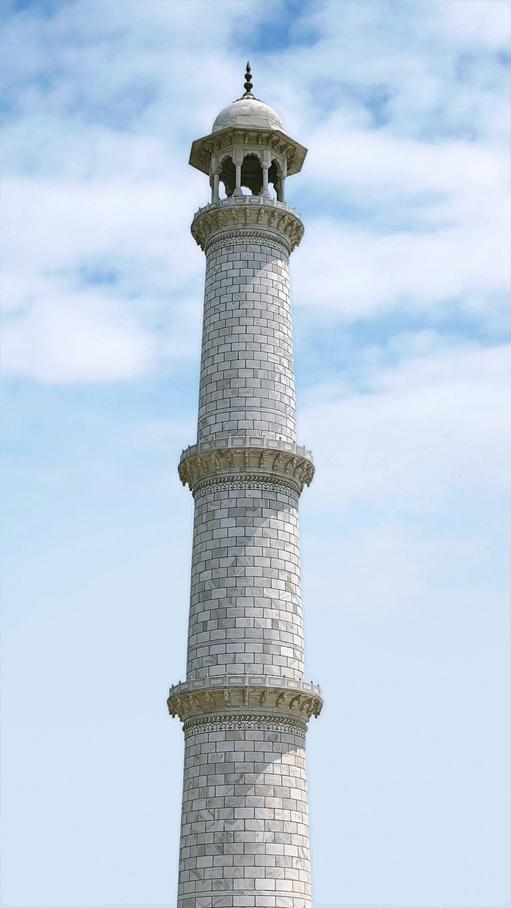 a tall white tower with a clock on top of it