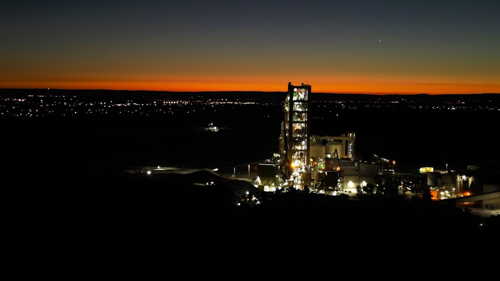 a large building lit up at night with a sky background