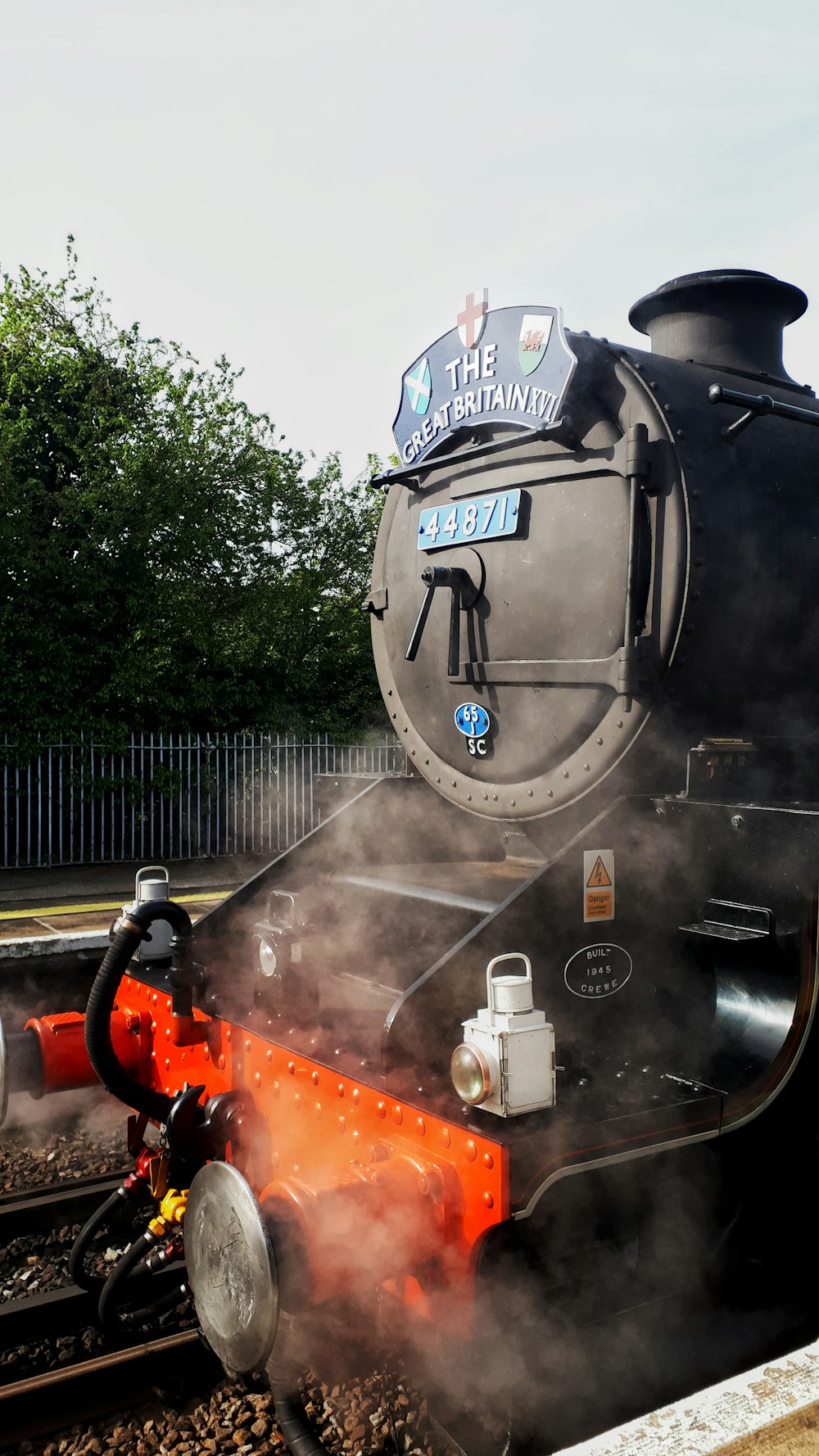 a steam engine train traveling down train tracks