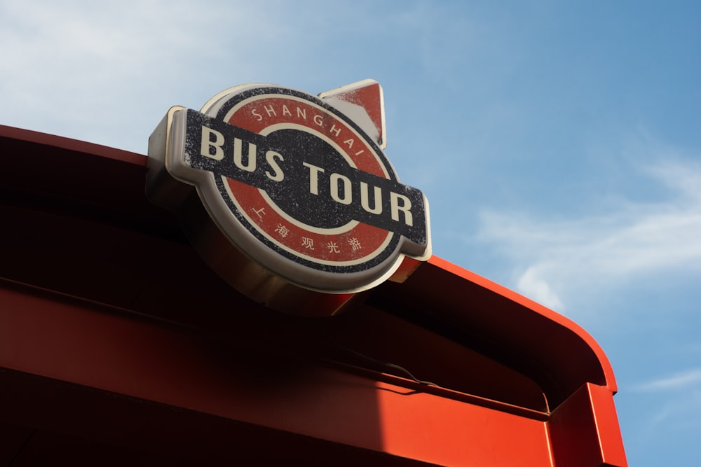 a bus tour sign on top of a red building