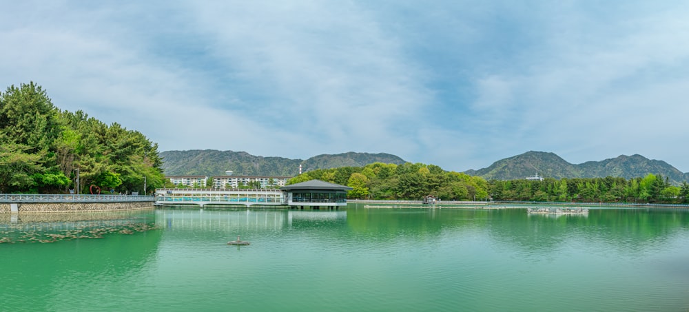 a body of water surrounded by trees and mountains