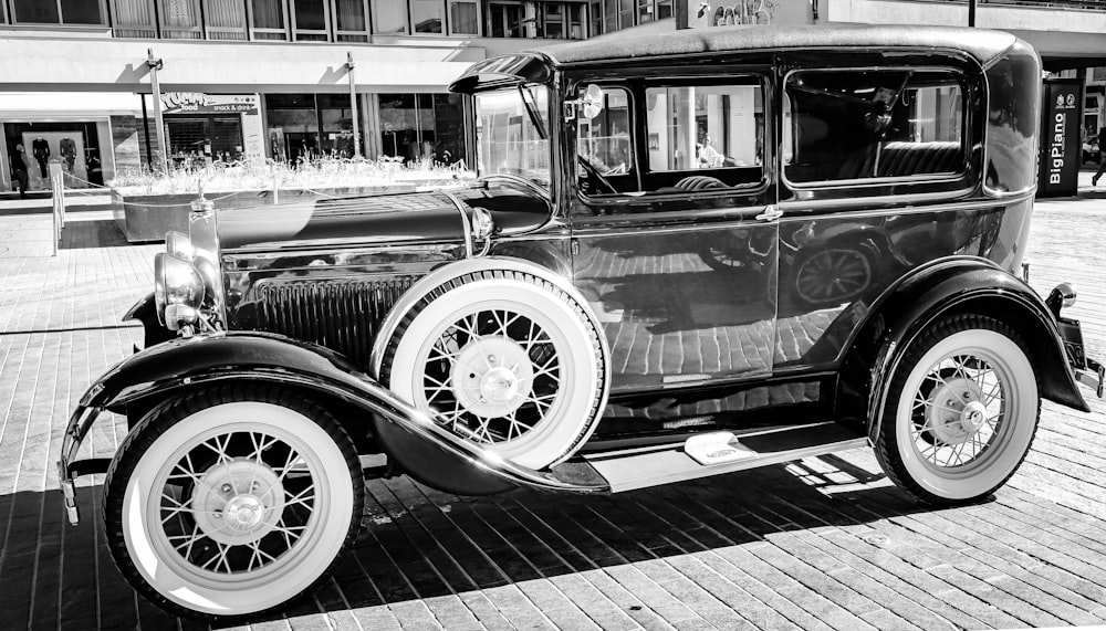 a black and white photo of an old car