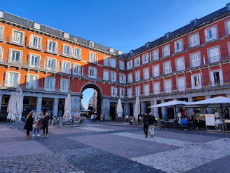 a group of people walking around a courtyard