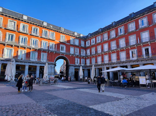 a group of people walking around a courtyard