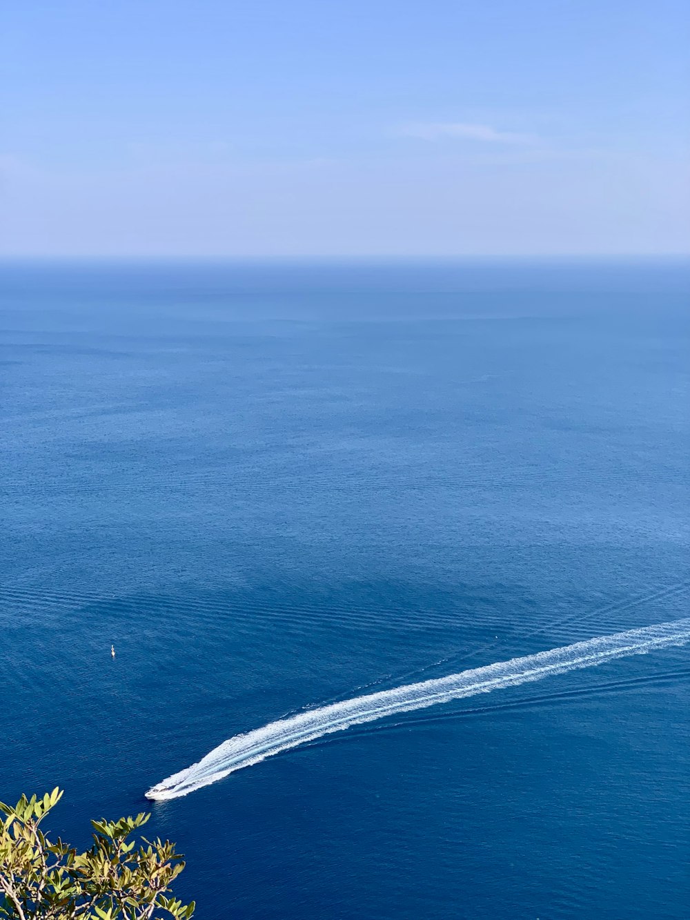 a boat is traveling through the water near the shore