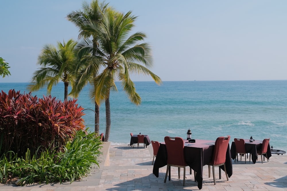 a table and chairs on a patio overlooking the ocean