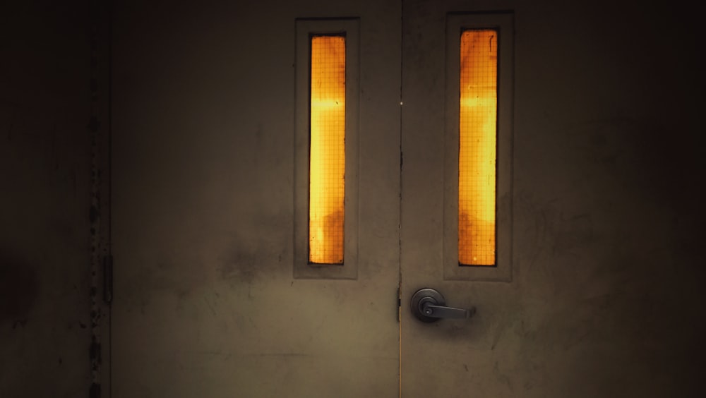 a white door with two yellow lights on it