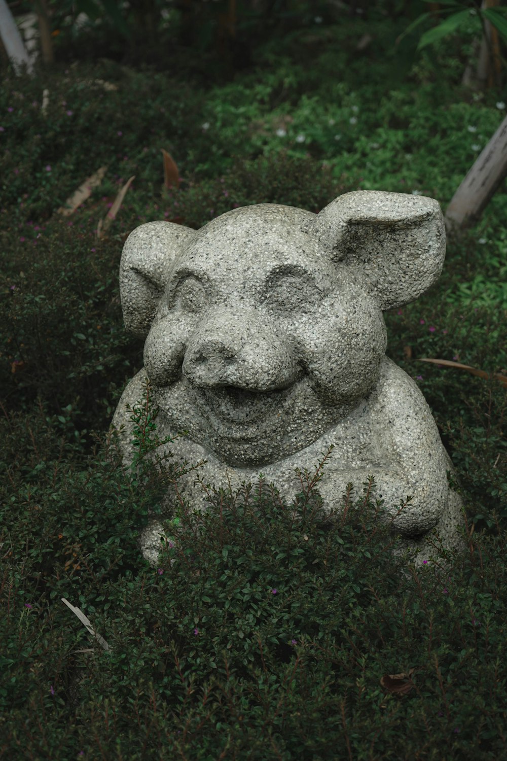 a statue of an elephant in the grass
