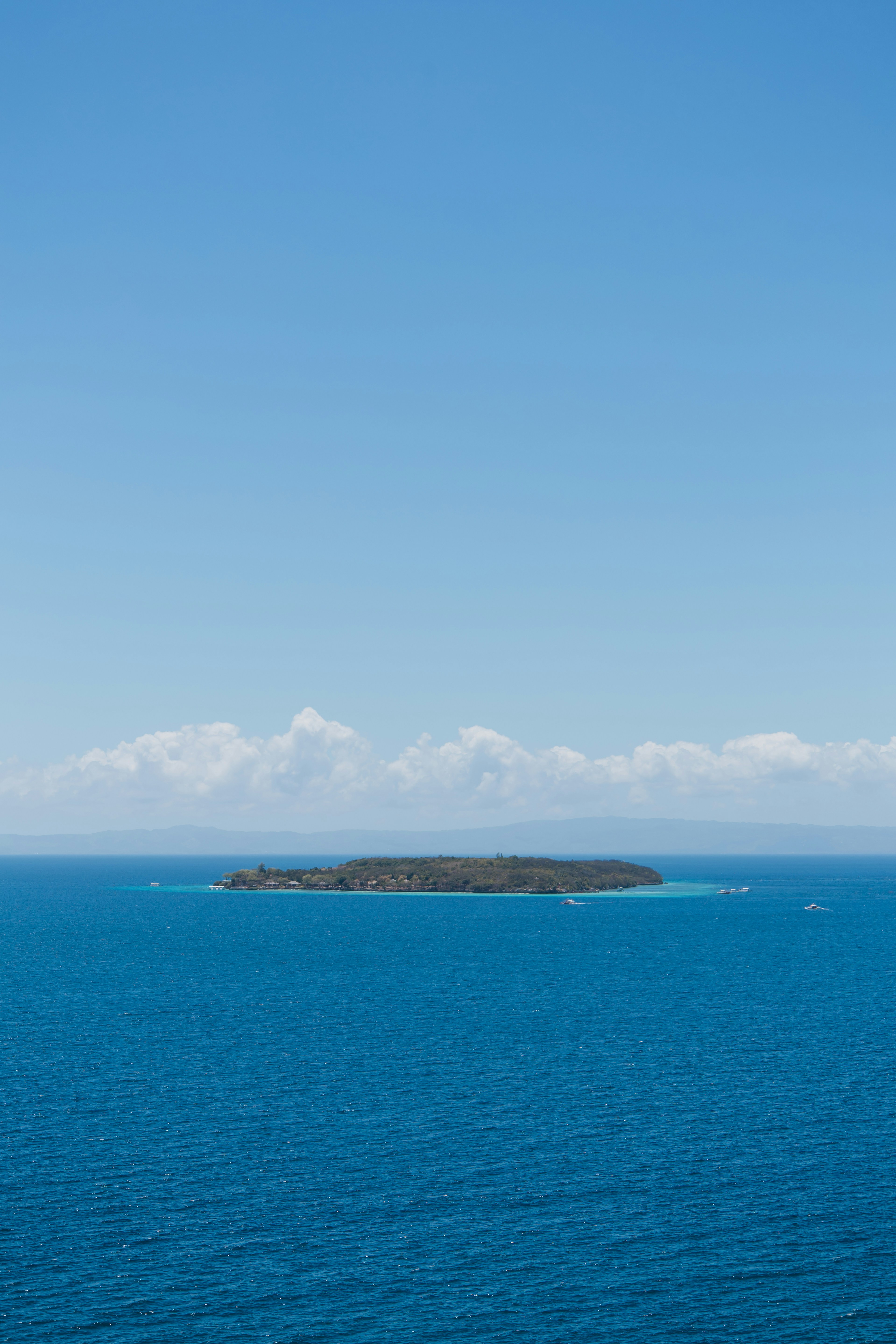 a large body of water with a small island in the distance