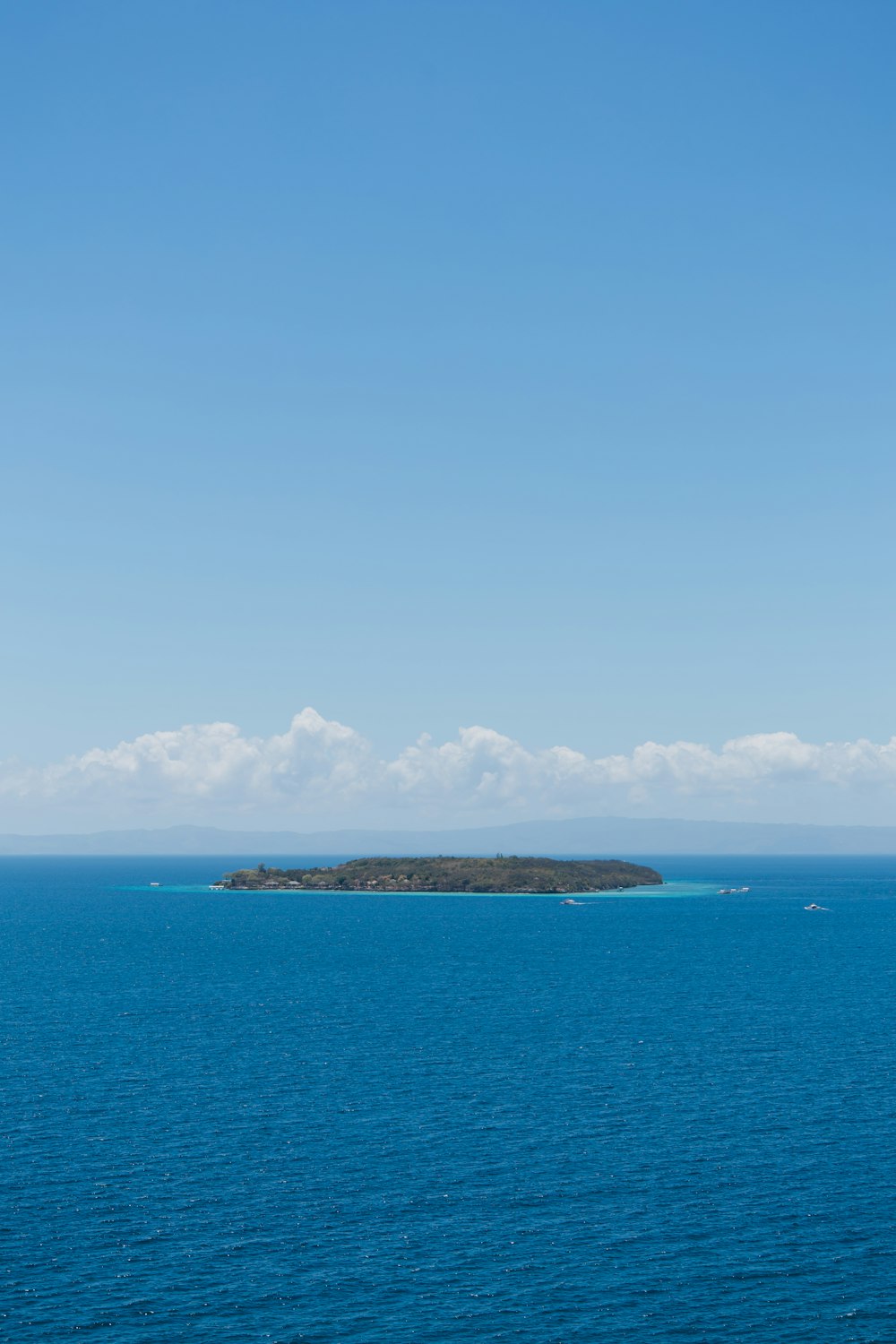 a large body of water with a small island in the distance