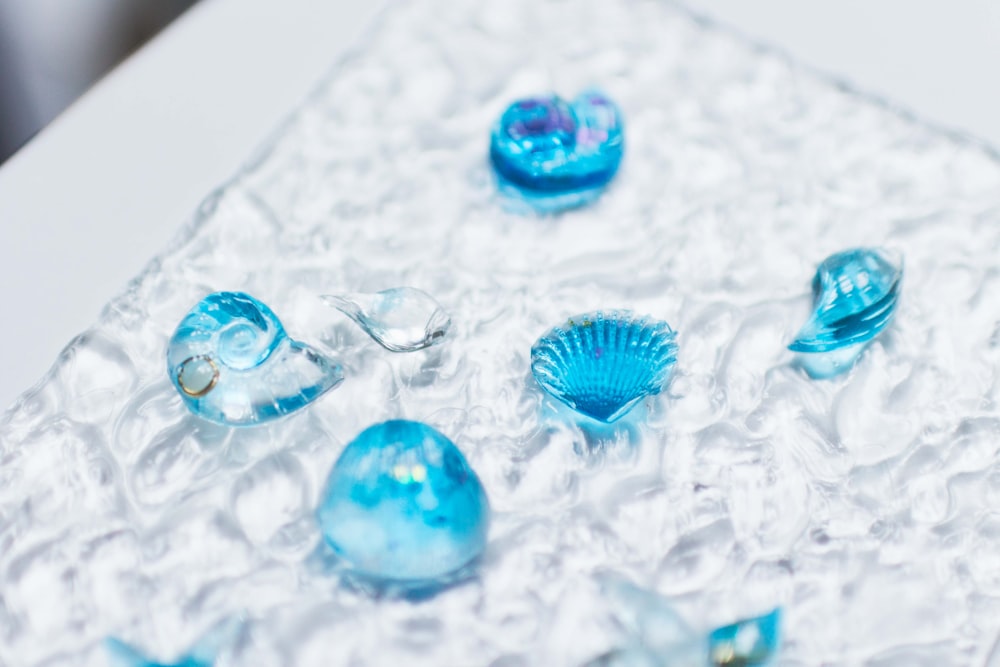 a group of blue glass objects sitting on top of a table