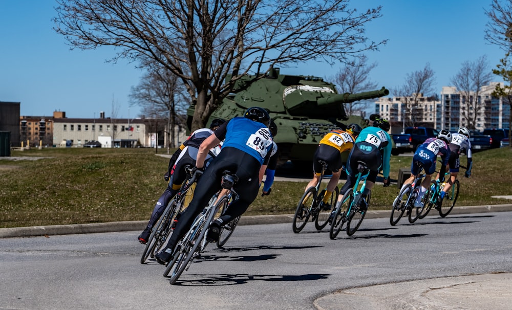 a group of people riding bikes down a street