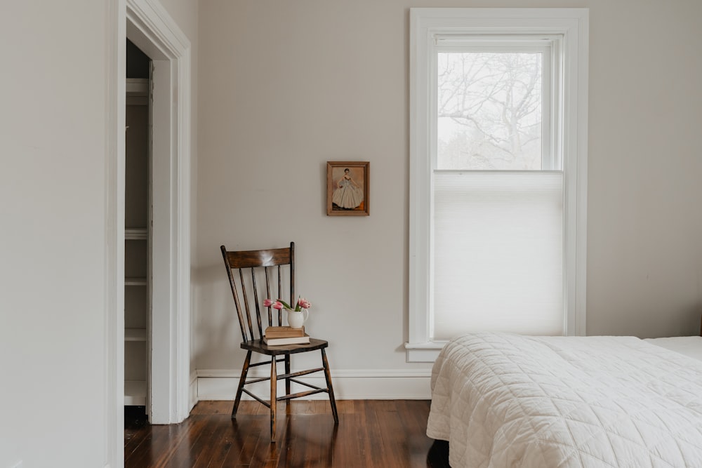 a bedroom with a bed and a chair in it