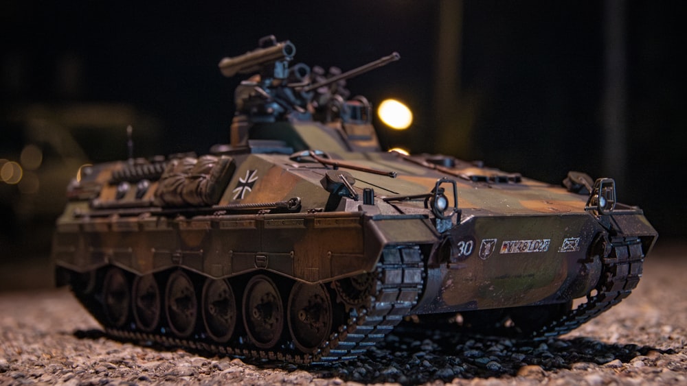a close up of a toy tank on a ground