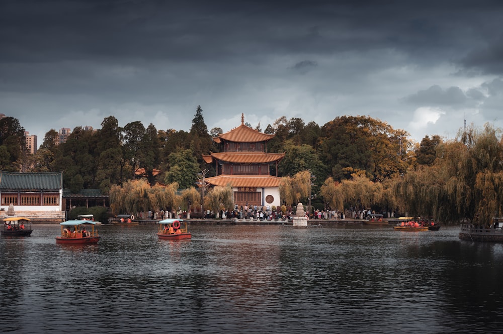 a group of boats floating on top of a lake