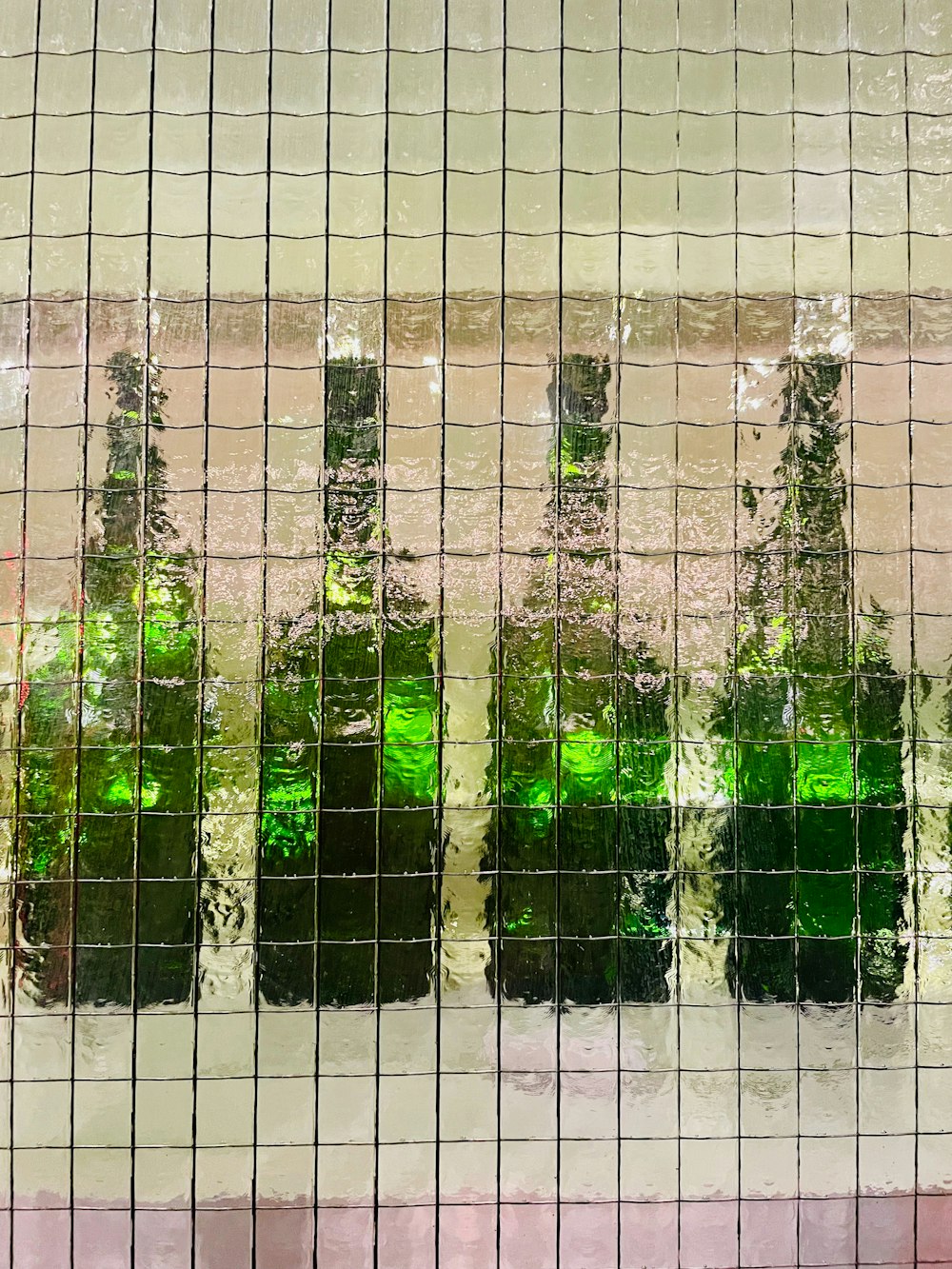 a group of green bottles sitting on top of a window sill