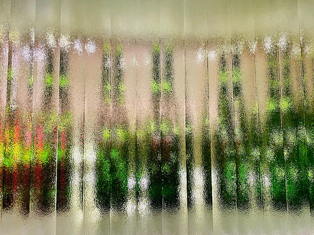 a picture of a window with trees outside of it