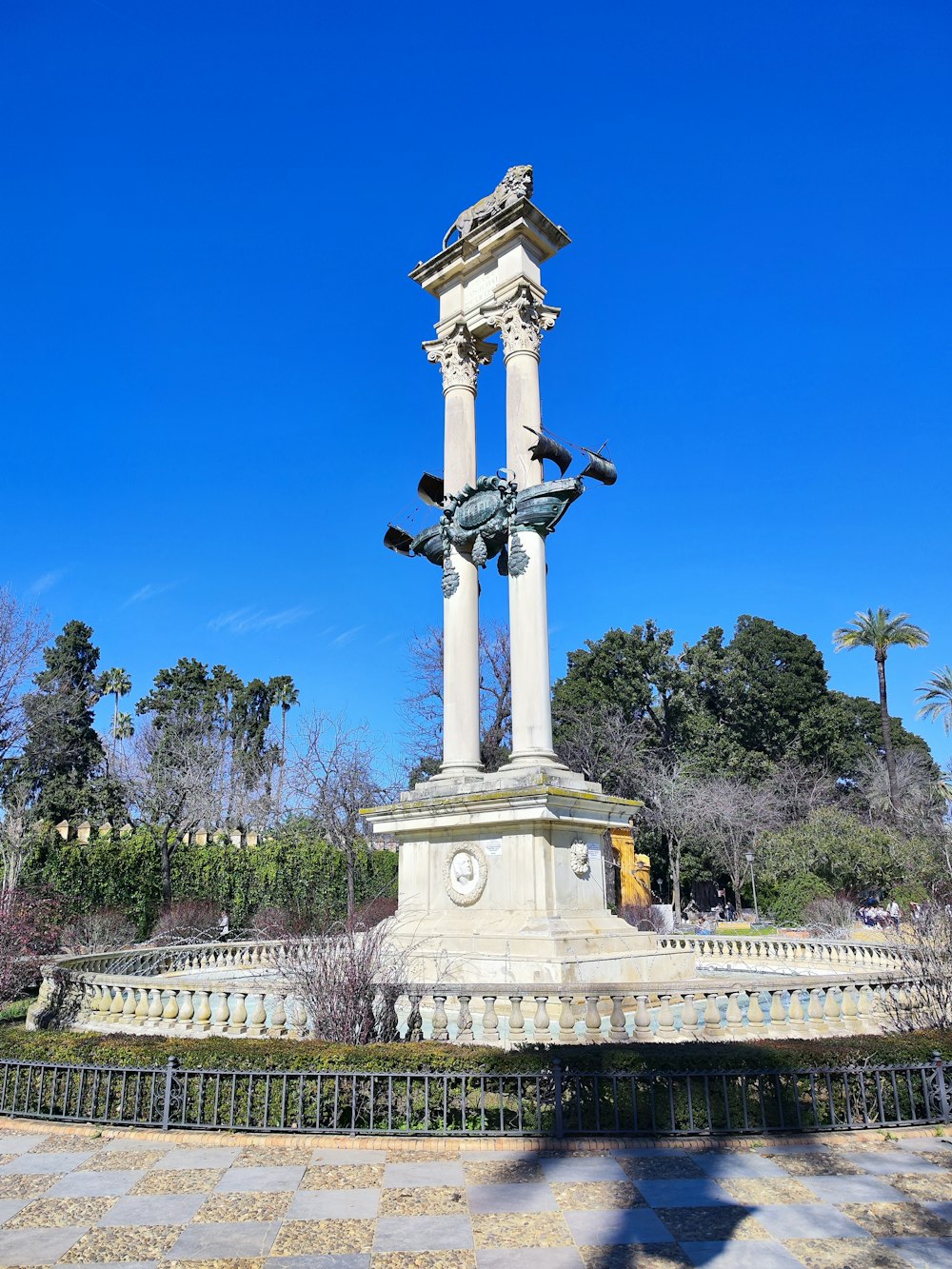 a statue of a horse on a pedestal in a park