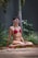 a woman in a red bikini sitting in a yoga position
