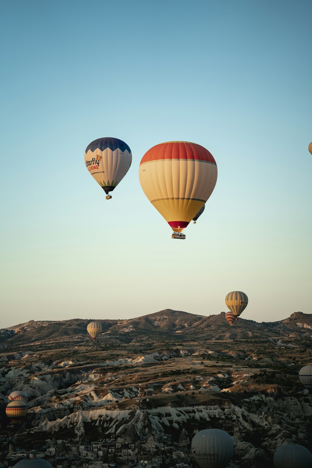 a group of hot air balloons flying in the sky