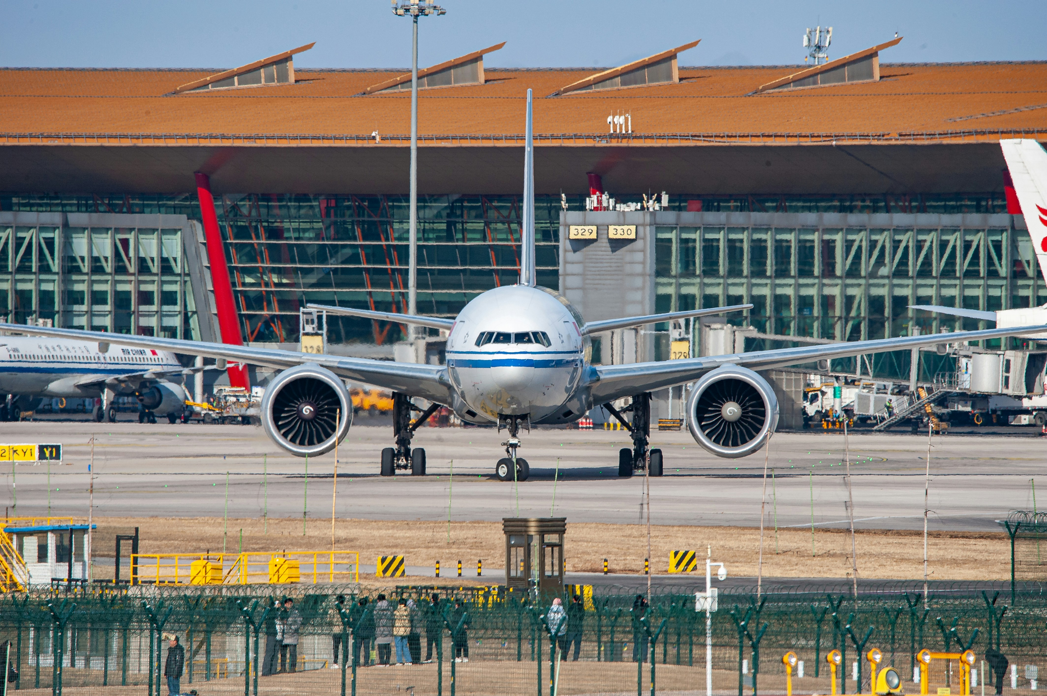 a large jetliner sitting on top of an airport tarmac, 