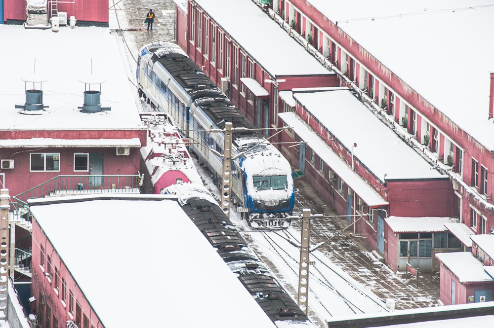 a train traveling through a snow covered train station