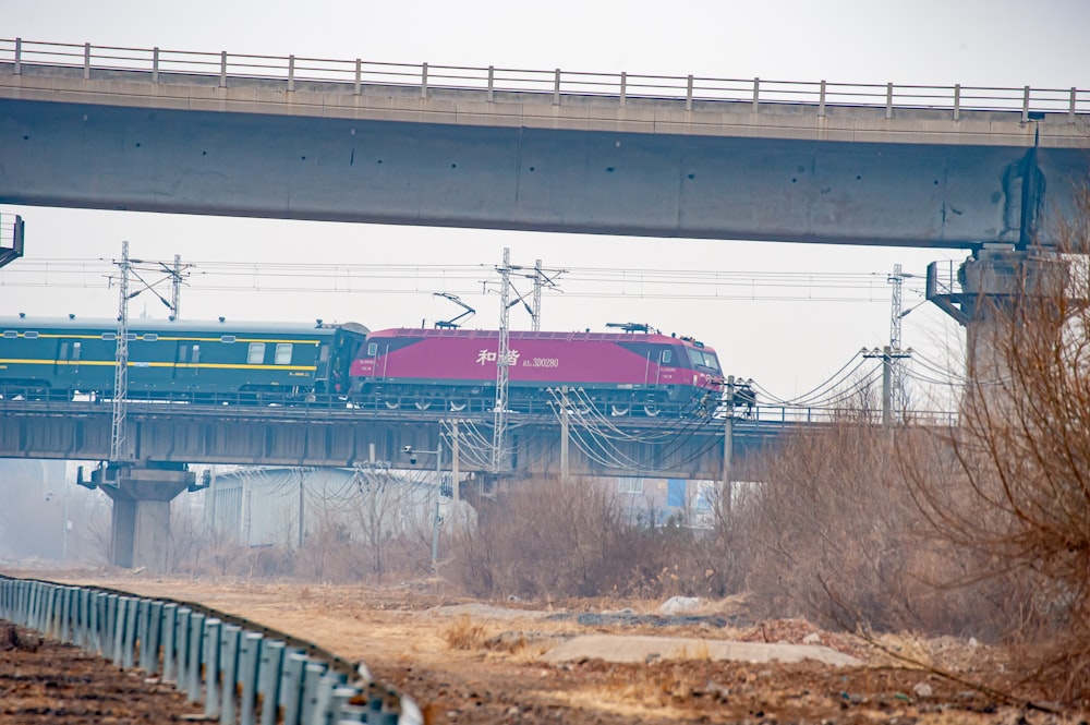 a train traveling over a bridge on a cloudy day