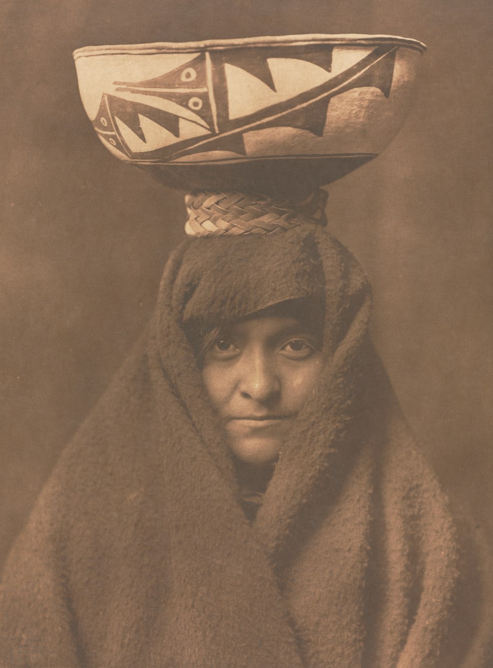 an old photo of a woman with a bowl on her head