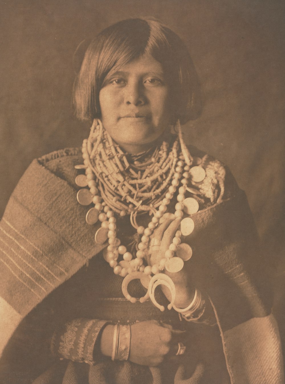 an old photo of a woman wearing a necklace