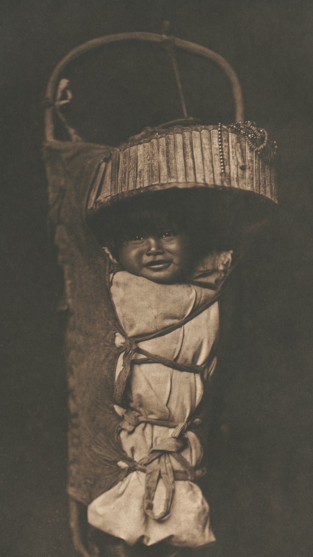 a black and white photo of a baby wearing a hat