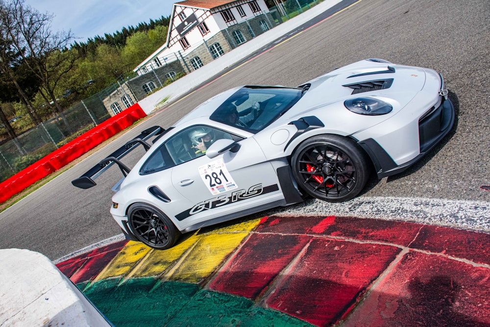 a white sports car on a race track