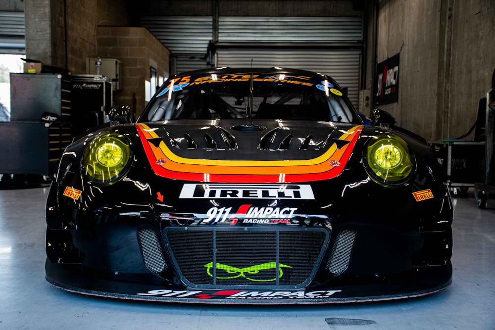 a black sports car parked in a garage