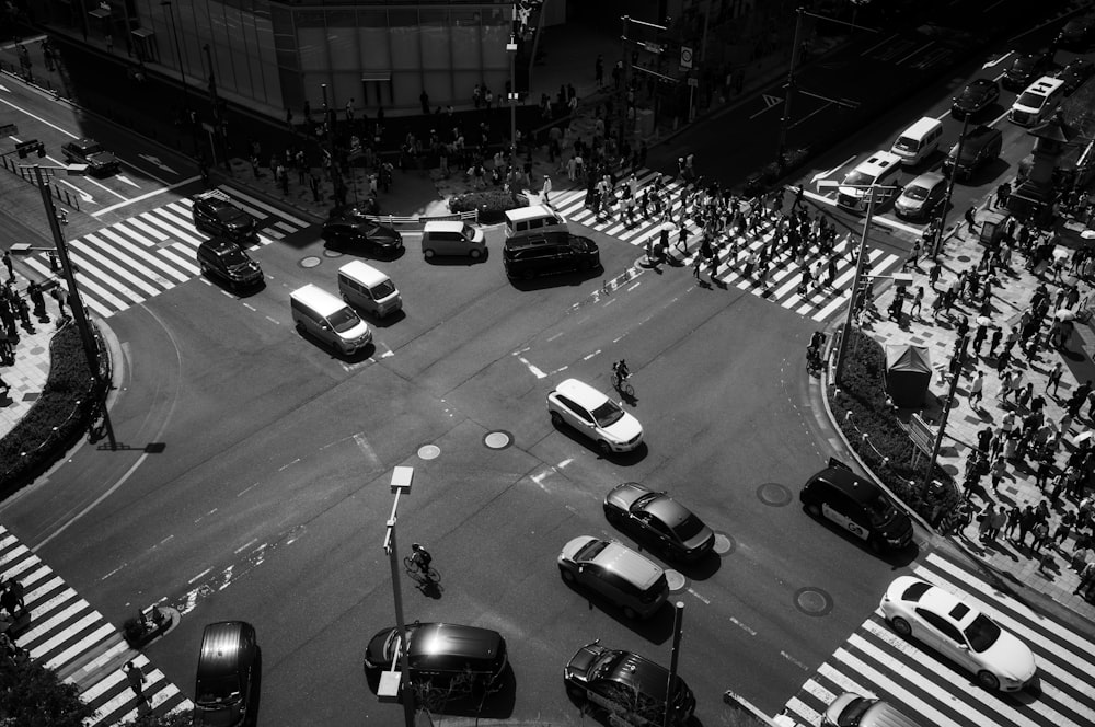 a black and white photo of a busy intersection