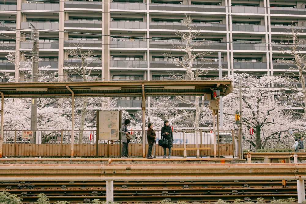 two people standing on a platform in front of a building