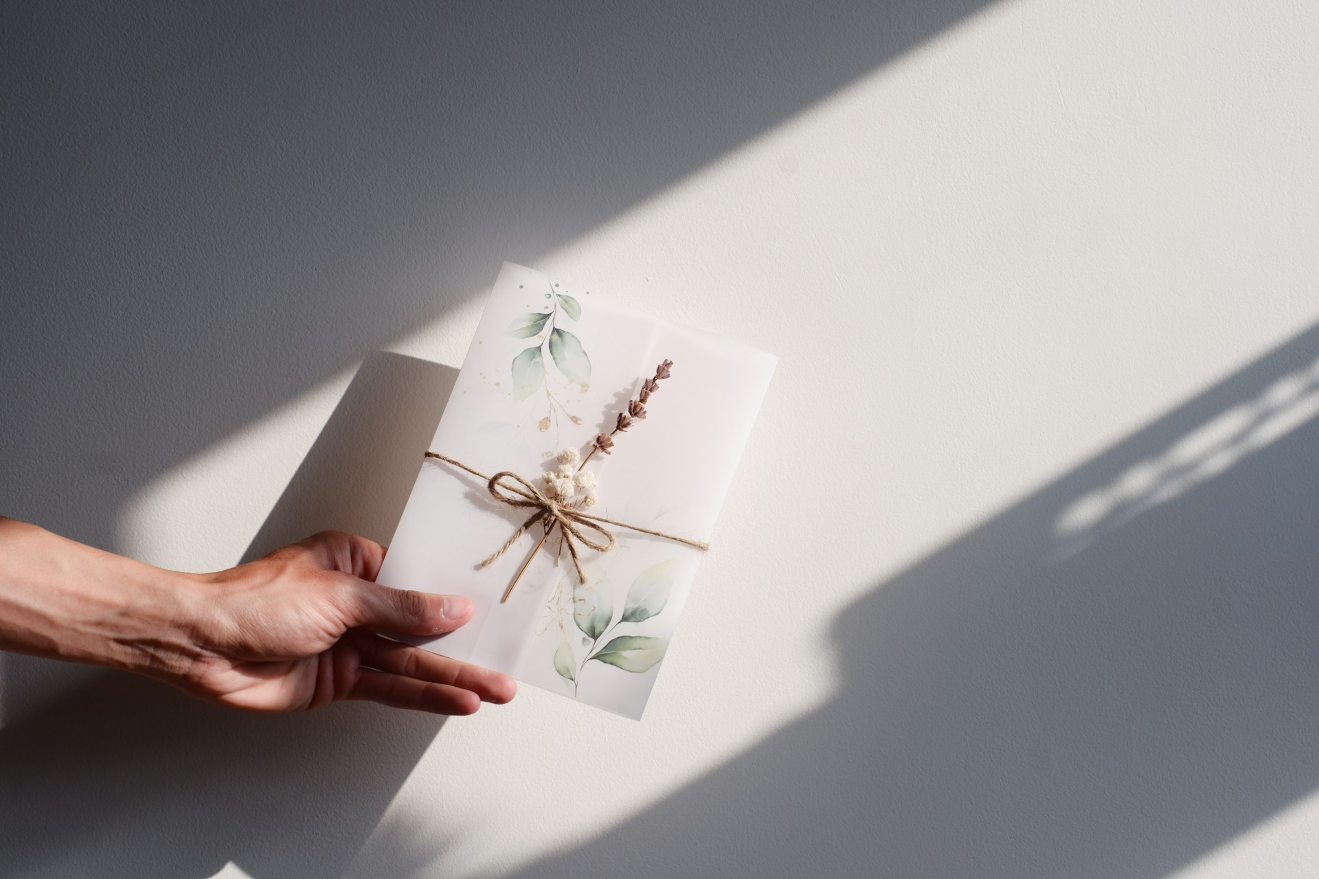 a person holding a card with a string tied to it