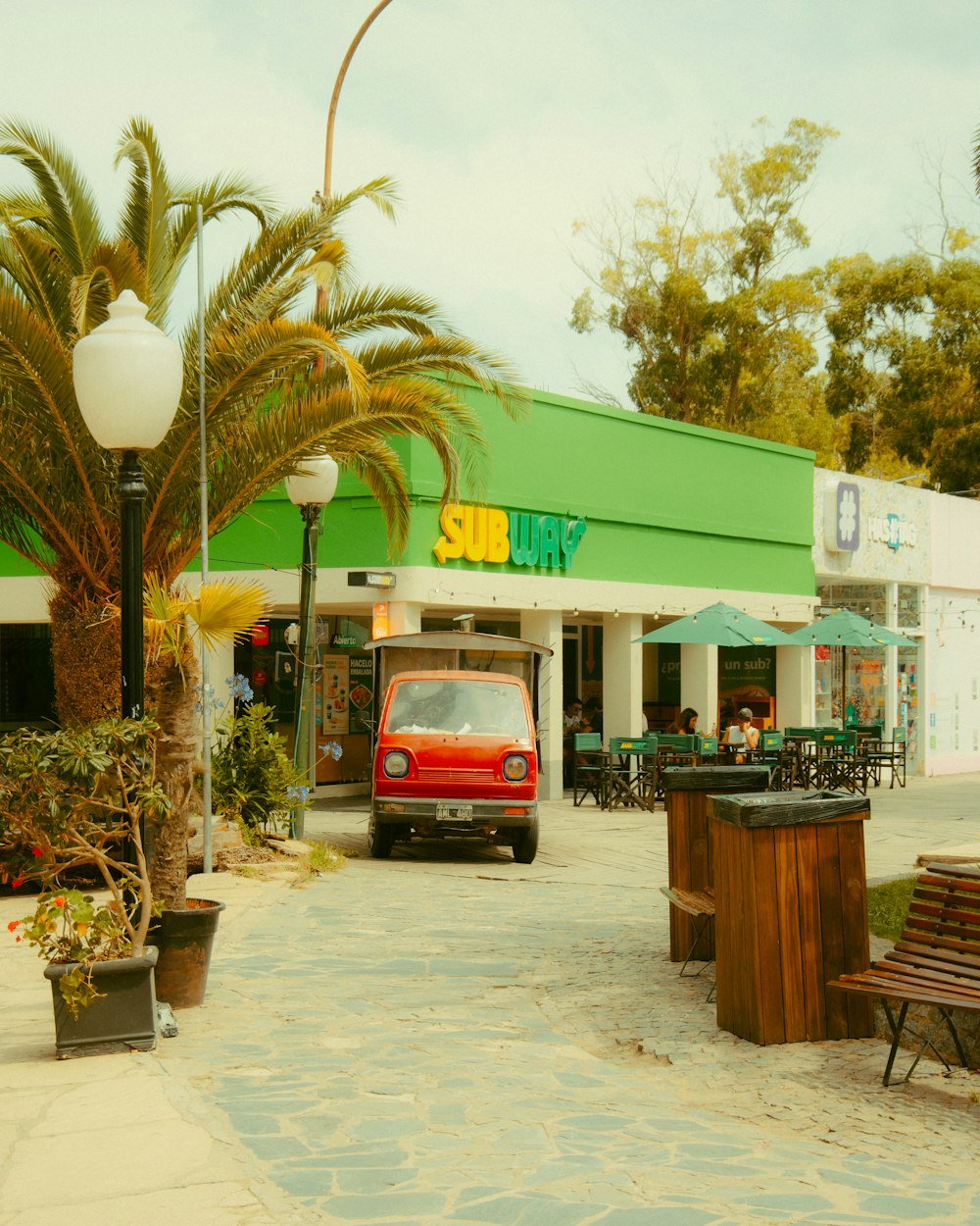 a small red car parked in front of a store