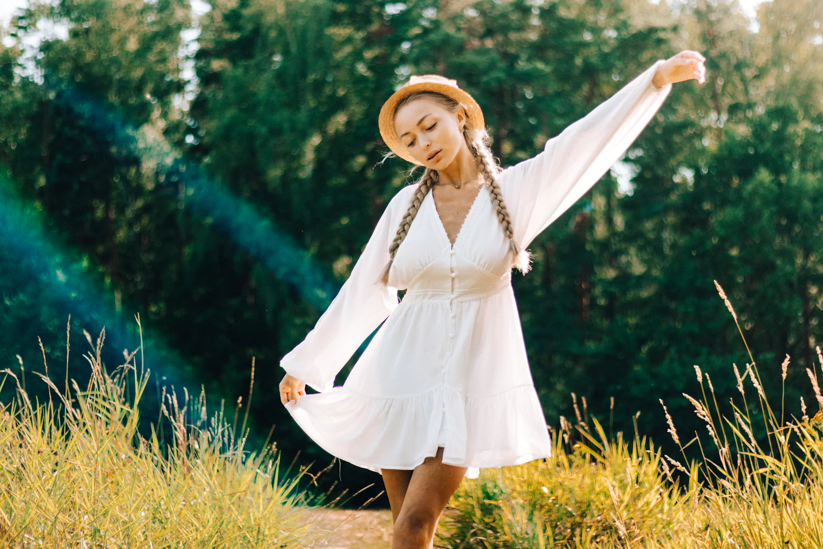 Woman in a white cotton dress twirling outdoors
