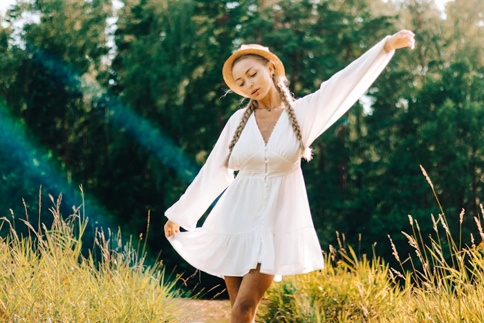 Woman in a white dress and straw hat