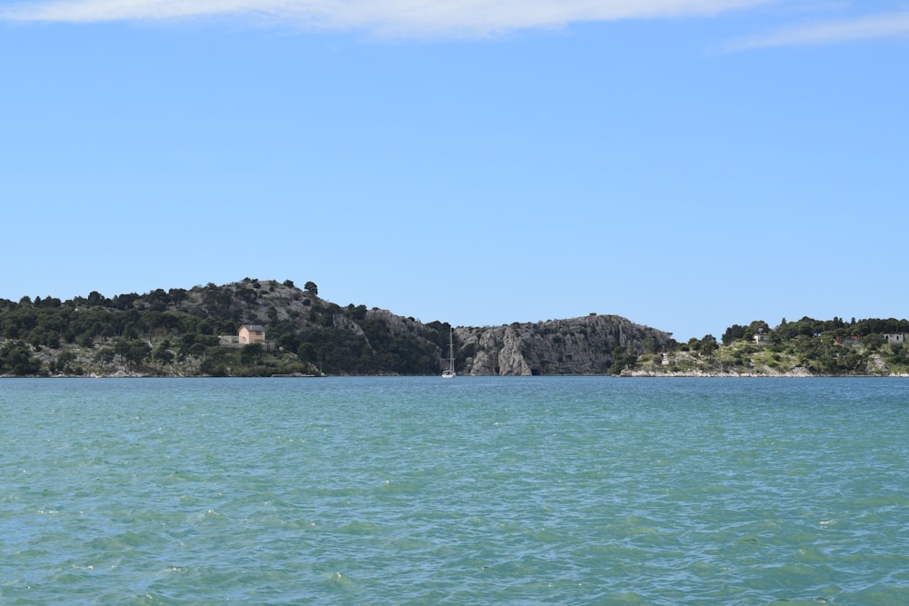 a large body of water with a small island in the background