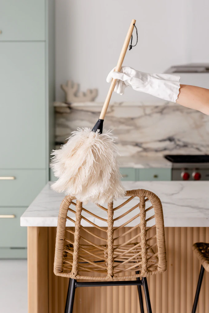 A cleaner detailing an upholstered chair