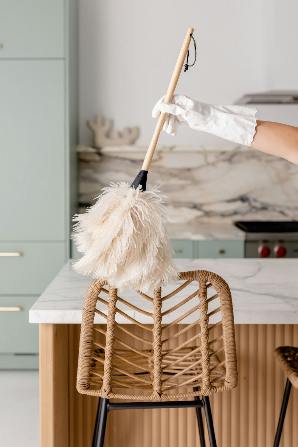 a person in white gloves is cleaning a chair