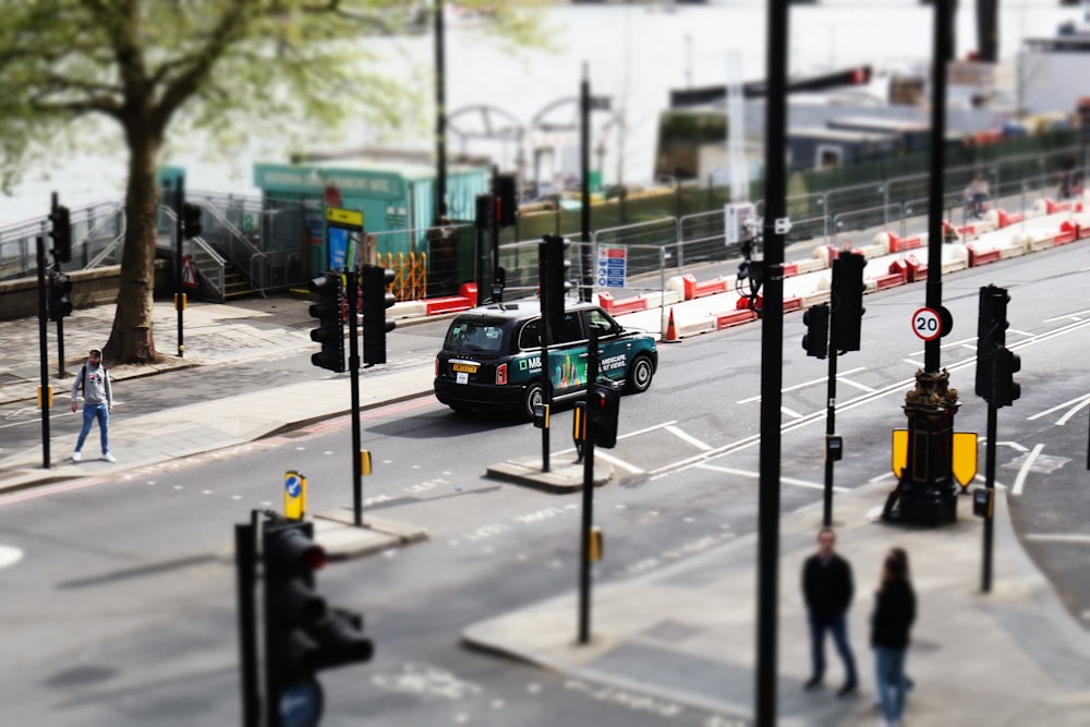 a busy city street with traffic lights and pedestrians