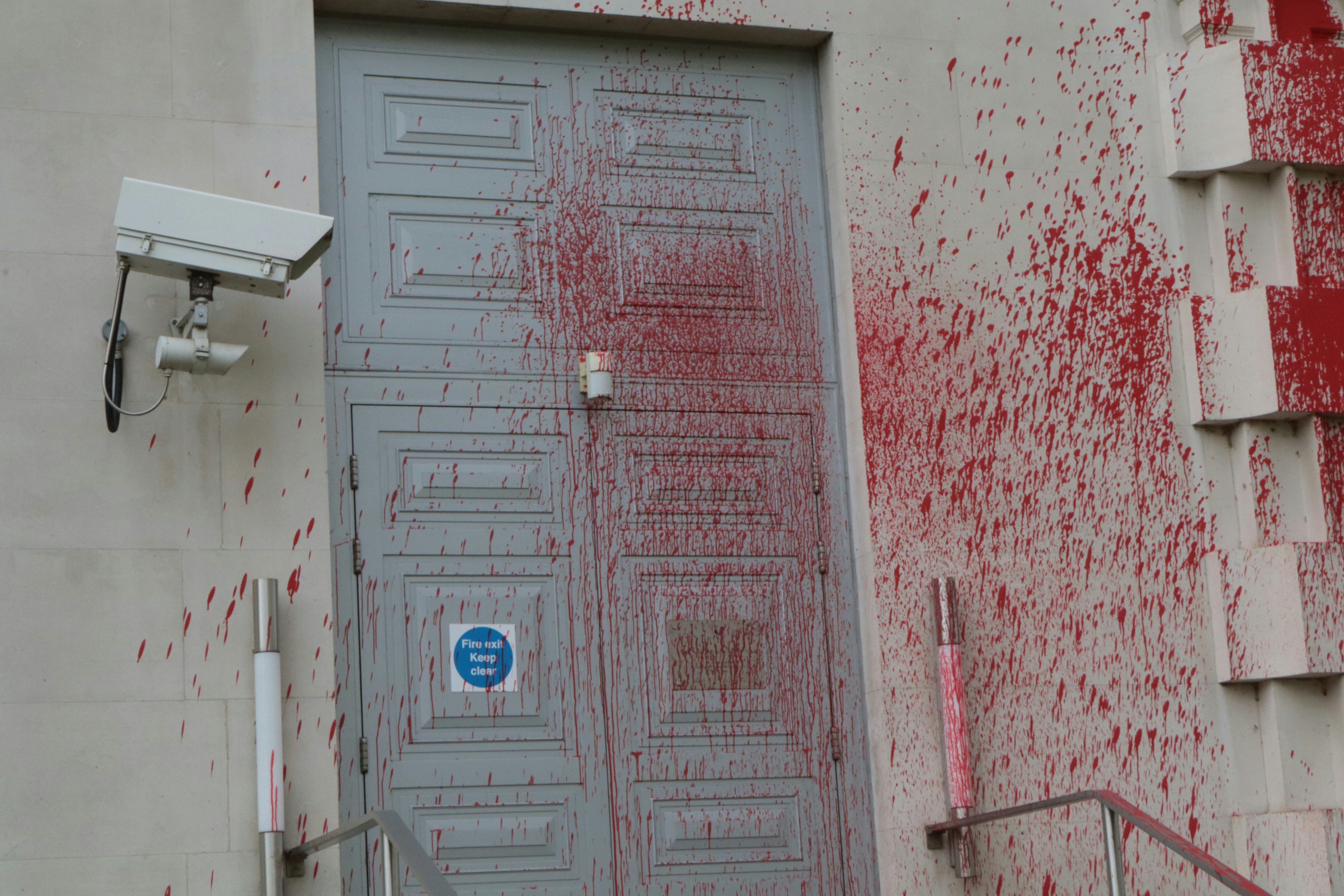 a door with red paint splattered all over it