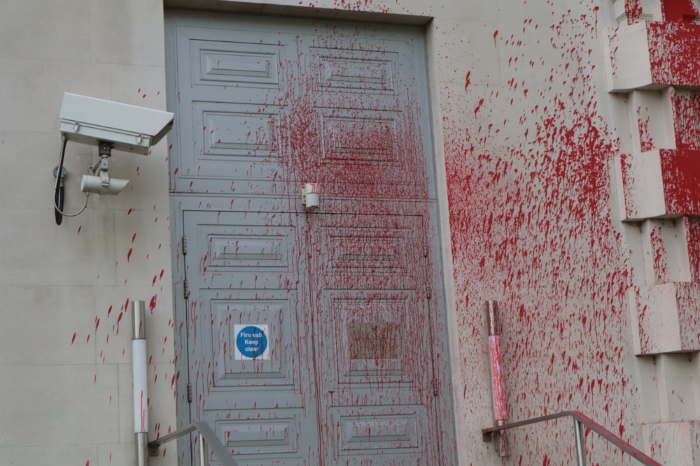 a door with red paint splattered all over it