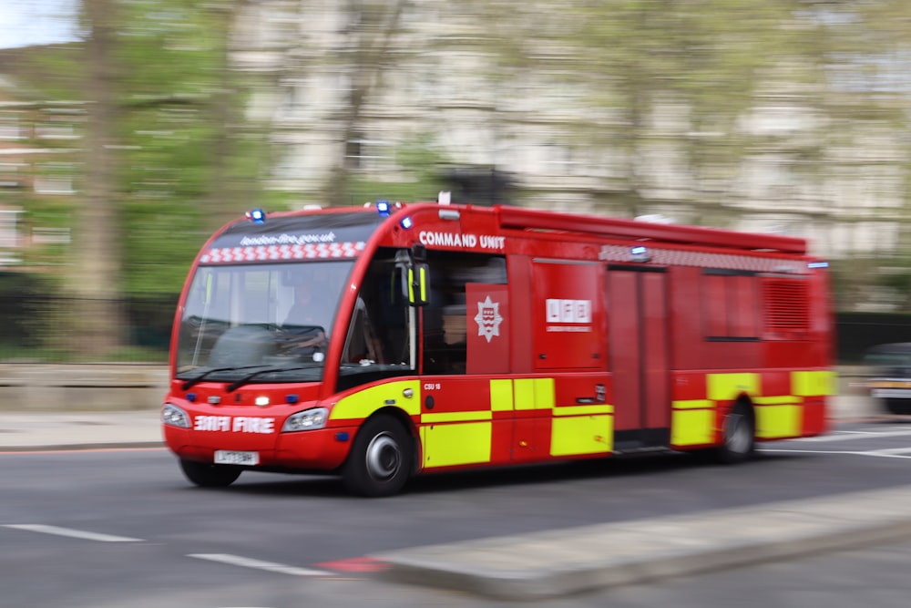 a red fire truck driving down a street